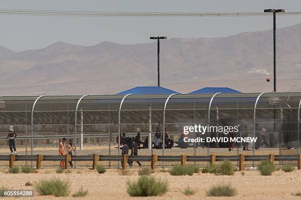Imprisoned immigrants are seen at the US Immigration and Customs Enforcement Adelanto Detention Facility near the border of the "green zone," an area...