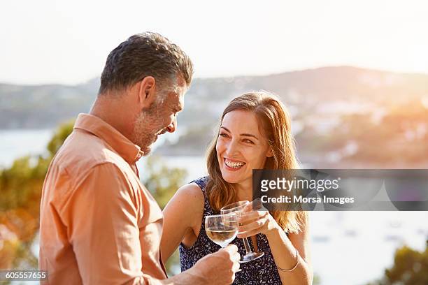 happy woman toasting wineglass with man - brown hair drink wine stock pictures, royalty-free photos & images