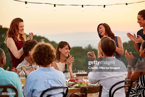 friends clapping while enjoying dinner party - reunião de amigos imagens e fotografias de stock