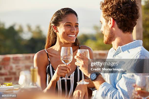 woman toasting wine glass with male friend - brown hair drink wine stock pictures, royalty-free photos & images