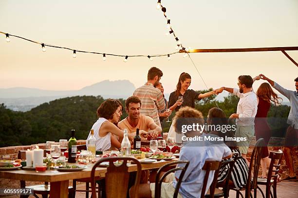 friends enjoying at patio during social gathering - barcelona spain fotografías e imágenes de stock