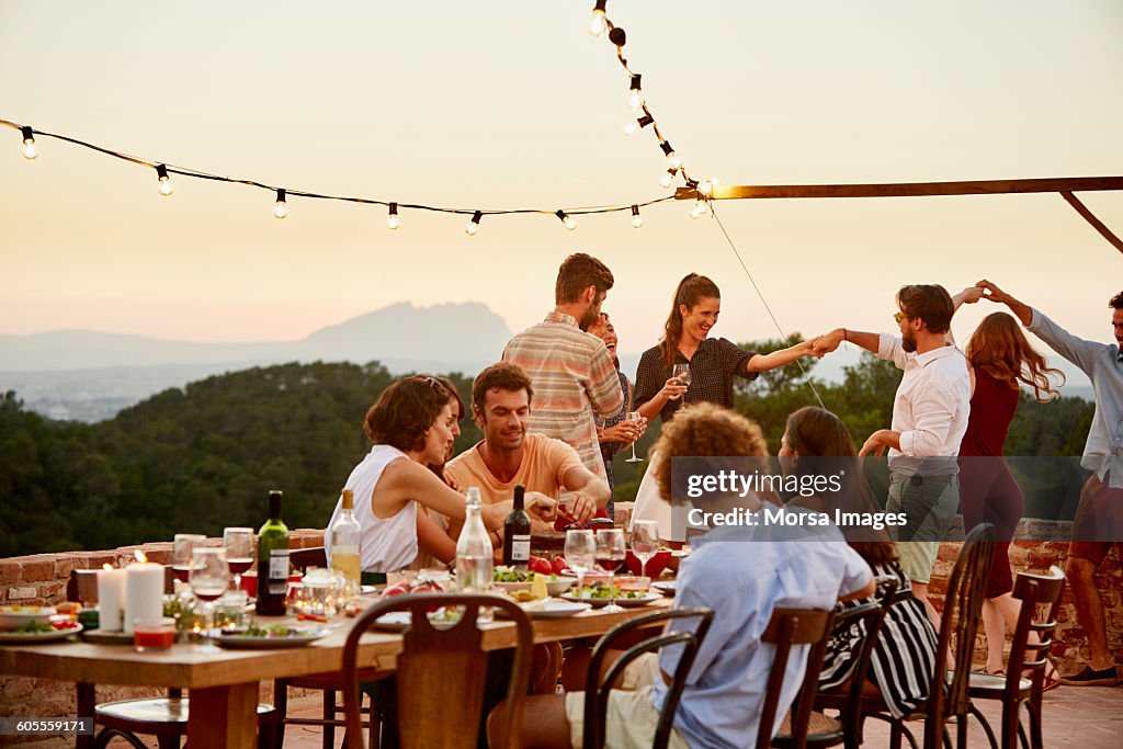 Friends enjoying at patio during social gathering