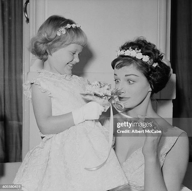 English novelist Jackie Collins as a bridesmaid at the wedding of actress Adrienne Scott and England rugby trialist and Wasps forward Gordon Benson,...