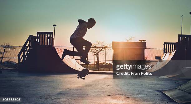 skateboarder jumping - half pipe stock-fotos und bilder