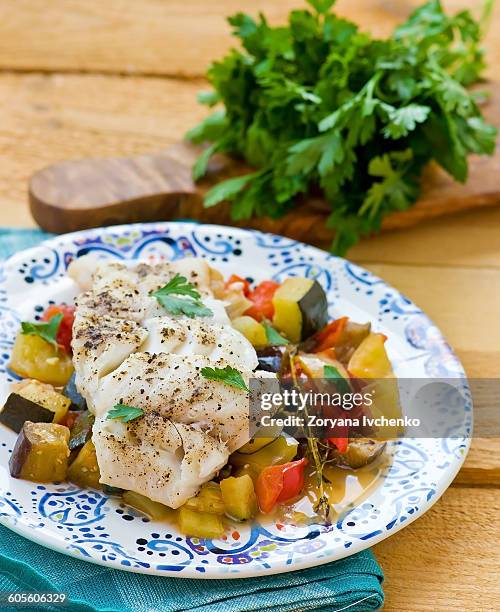 stewed cod fish with vegetables - kabeljauw stockfoto's en -beelden