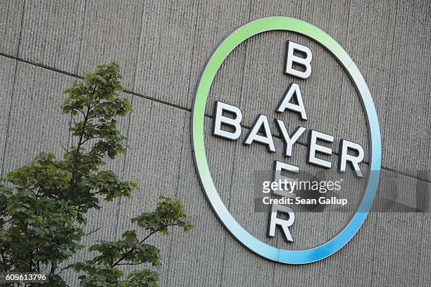 The logo of German pharmaceuticals and chemicals giant Bayer stands over Bayer corporate offices on September 14, 2016 in Berlin, Germany. The...