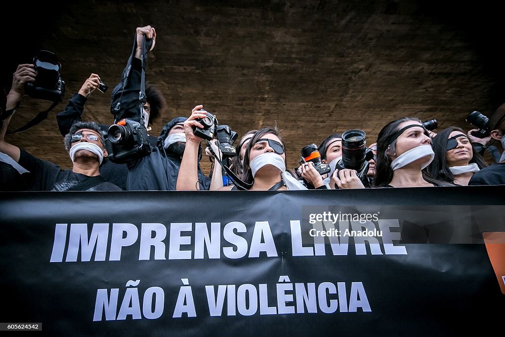 Press members demonstrate against the violence in Brazil