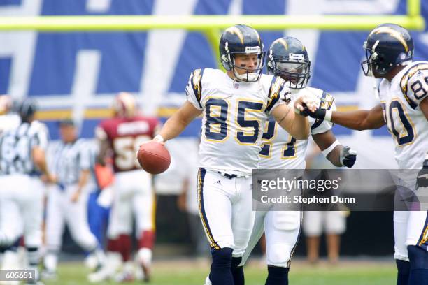 Wide receiver Tim Dwight of the San Diego Chargers celebrates his punt return for a touchdown with running back LaDainian Tomlinson and wide receiver...