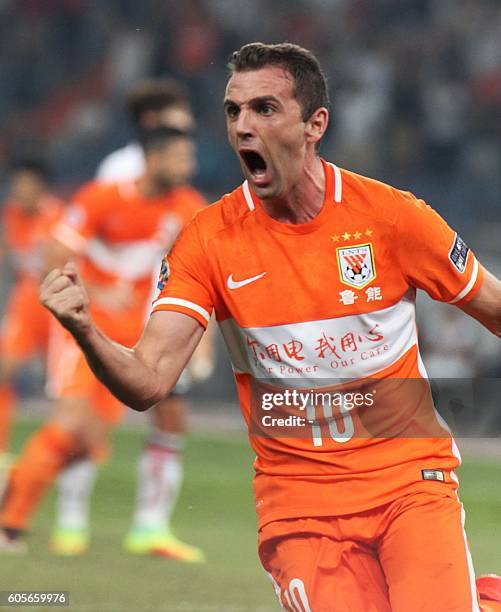 Walter Montillo of Shandong Luneng celebrates a goal against FC Seoul during their AFC Champions League football match in Jinan, in China's Shandong...