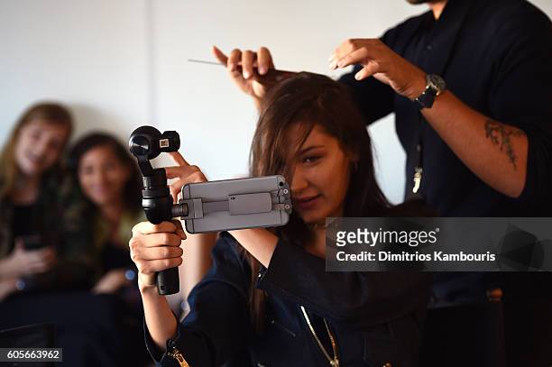Model Bella Hadid takes a video with the DJI Osmo Mobile backstage at the Michael Kors Spring 2017 Runway Show during New York Fashion Week at Spring...