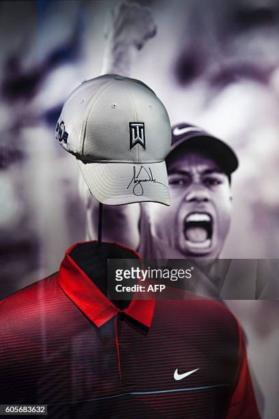 Signed hat and shirt from PGA golfer Tiger Woods are on display during a press preview at the Smithsonian's National Museum of African American...