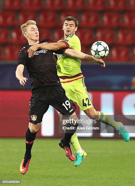 Julian Brandt of Bayer Leverkusen and Georgi Schennikov of CSKA Moscow challenge for the ball during the UEFA Champions League match between Bayer 04...