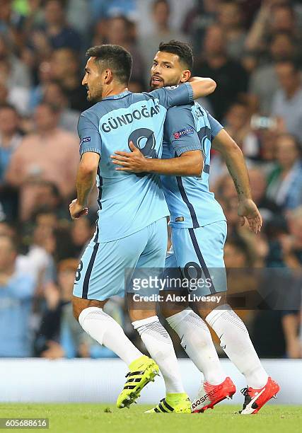 Ilkay Gundogan congratulates Sergio Aguero of Manchester City after scoring his teams opener during the UEFA Champions League match between...