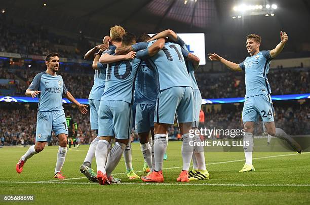 Manchester City's English defender John Stones and Manchester City's Spanish midfielder Jesus Navas join the celebration after Manchester City's...