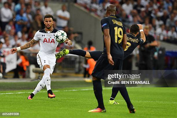 Tottenham Hotspur's English defender Kyle Walkerb crosses the ball past Monaco's Portuguese midfielder Joao Moutinho during the UEFA Champions League...