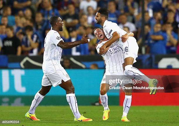 Riyad Mahrez of Leicester City celebrates with team mates Wes Morgan and Daniel Drinkwater during the UEFA Champions League match between Club Brugge...