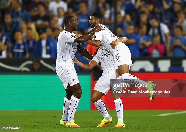 Riyad Mahrez of Leicester City celebrates with team mates Wes Morgan and Daniel Drinkwater during the UEFA Champions League match between Club Brugge...