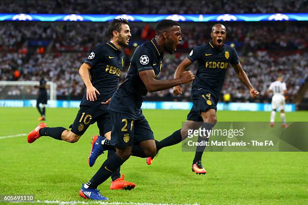 Thomas Lemar of AS Monaco runs off in celebration with team-mates Bernardo Silva and Djibril Sidibe during the UEFA Champions League match between...