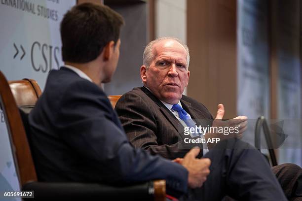 Director John Brennan speaks during a discussion with National Security Division Assistant Attorney General John Carlin during a conference between...