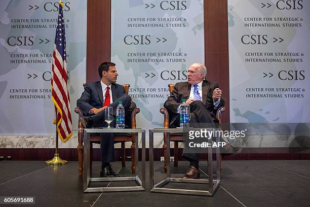 Director John Brennan speaks during a discussion with National Security Division Assistant Attorney General John Carlin during a conference between...