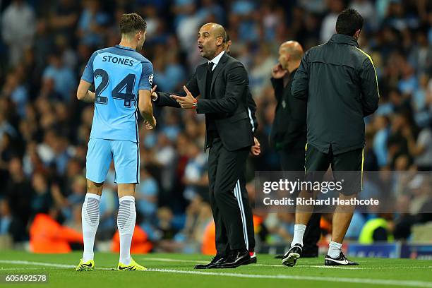John Stones of Manchester City speaks to his manager, Josep Guardiola ring the UEFA Champions League match between Manchester City FC and VfL...