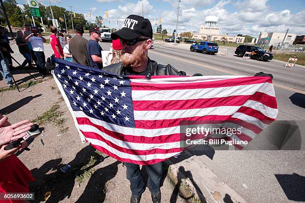 Pro-Trump supporter waits for Republican presidential nominee Donald Trump to arrive for a visit to the Flint Water Treatment Plant September 14,...