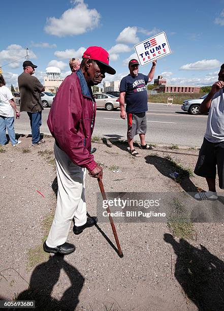 An anti-Trump protestor and a pro-Trump supporter exchange words while waiting for Republican presidential nominee Donald Trump to arrive for a visit...