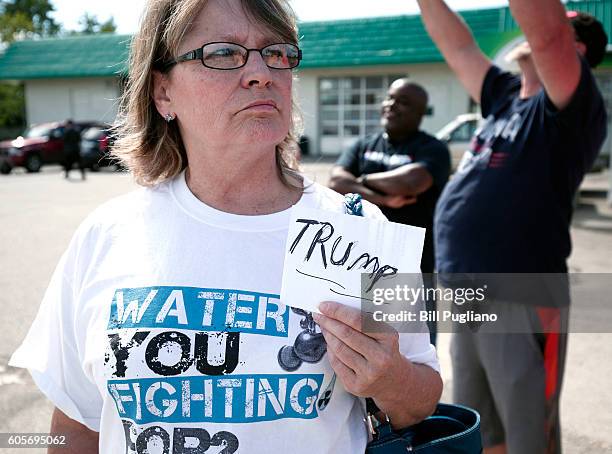 Pro-Trump supporter waits for Republican presidential nominee Donald Trump to arrive for a visit to the Flint Water Treatment Plant September 14,...