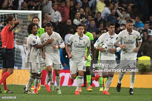 Real Madrid's Portuguese forward Cristiano Ronaldo celebrates with his teammates after scoring during the UEFA Champions League football match Real...