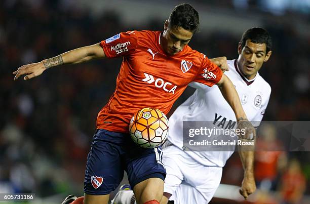 Jose Sand of Lanus fights for the ball with Jorge Figal of Independiente during a match between Independiente and Lanus as part of Copa Sudamericana...