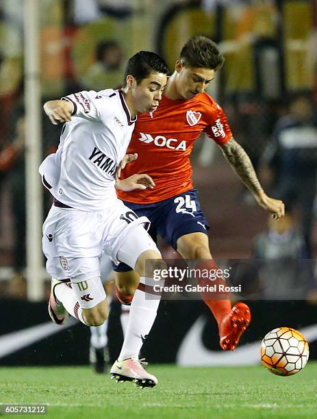 Miguel Almiron of Lanus fights for the ball with Emiliano Rigoni of Independiente during a match between Independiente and Lanus as part of Copa...