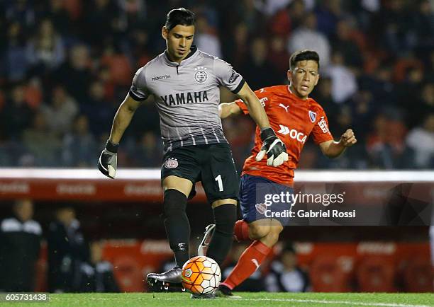 Fernando Monetti goalkeeper of Lanus fights for the ball with Ezequiel Barco of Independiente during a match between Independiente and Lanus as part...