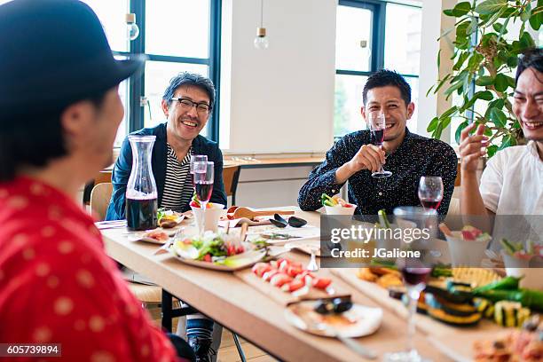 friends relaxing together - party food and drink stock pictures, royalty-free photos & images