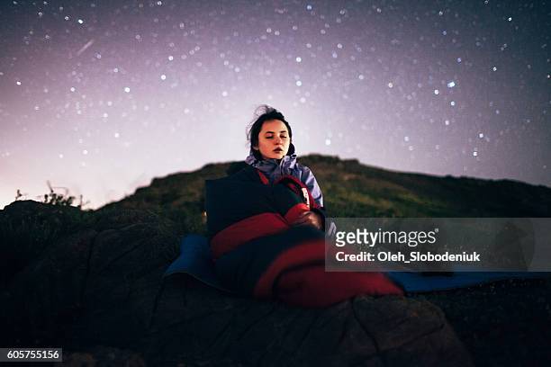 young girl sitting under the starry sky - beautiful armenian women stock pictures, royalty-free photos & images