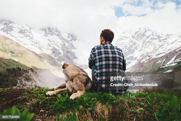 man with dog in mountains - georgian man stock pictures, royalty-free photos & images