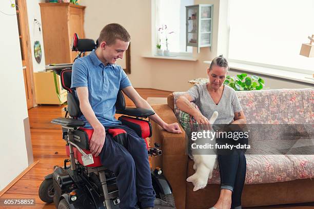 young cerebral palsy patient at home - amyotrophic lateral sclerosis stock pictures, royalty-free photos & images