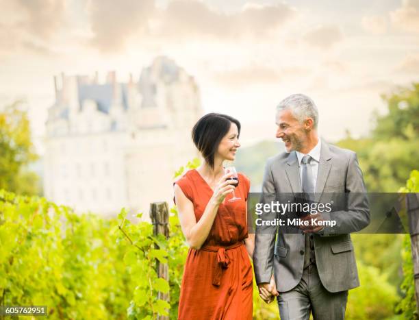 caucasian couple enjoying wine in vineyard - loire valley spring stock pictures, royalty-free photos & images