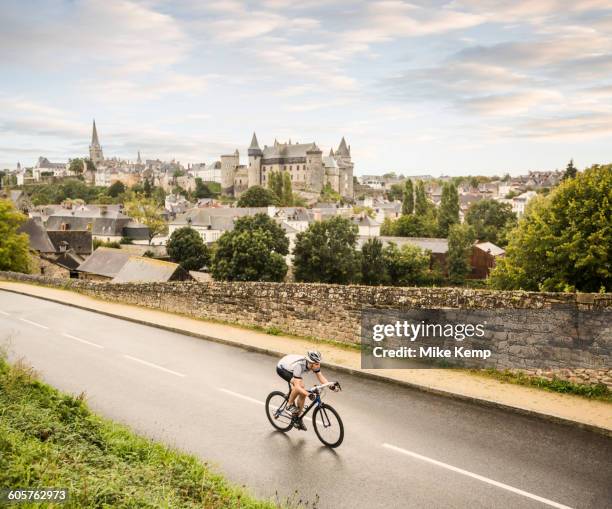 caucasian man cycling outdoors - vitré stock-fotos und bilder