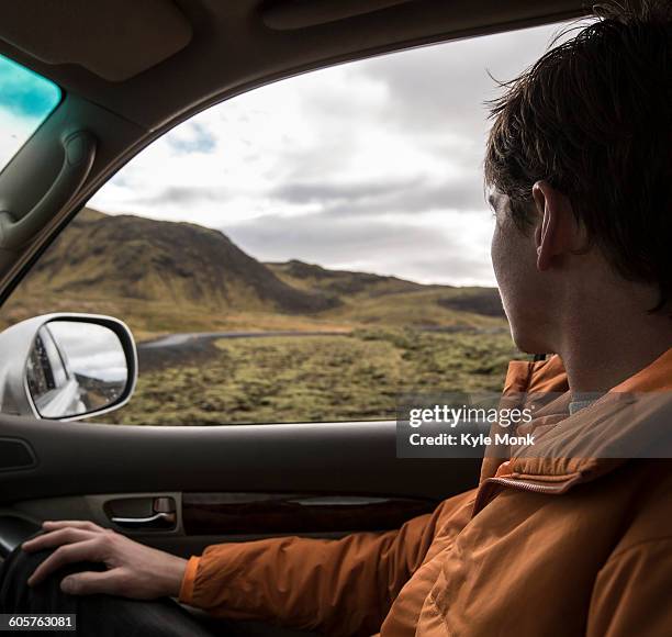 man driving in remote landscape - car view stock-fotos und bilder