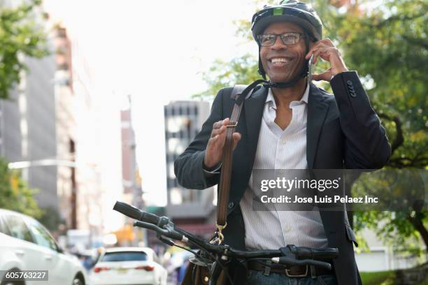 businessman talking on cell phone on bicycle - commuting to work stock pictures, royalty-free photos & images