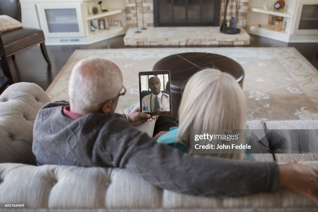 Older couple video chatting with digital tablet