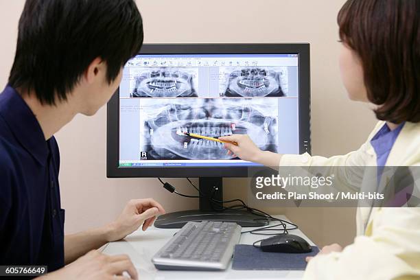 dentists discussing on computer monitor - dental record stock pictures, royalty-free photos & images