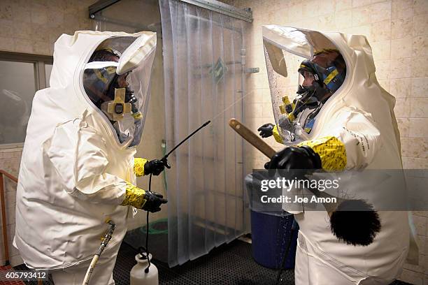 Instrumentation technician Philip Kell washes down his partner Eric Irvinin wash down area at the Pueblo Chemical agent Pilot plant training area....