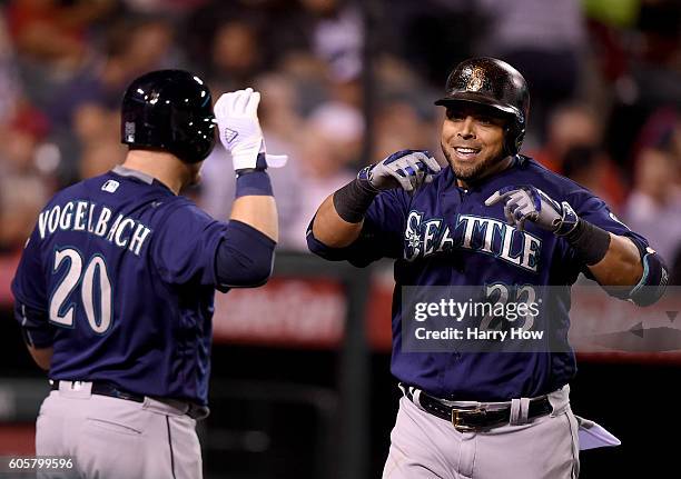 Nelson Cruz of the Seattle Mariners celebrates his solo homerun with Daniel Vogelbach of the Seattle Mariners to take a 2-1 lead over the Los Angeles...