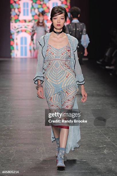 Model walks the runway during the Anna Sui September 2016 New York Fashion Week: The Shows Spring 2017 season at The Arc, Skylight at Moynihan...