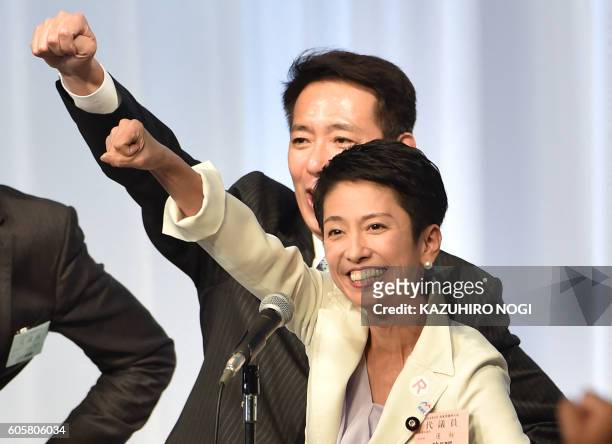 Renho, chosen for the new leader of the Democratic Party, raises her arm with party members at the end of their leadership election in Tokyo on...