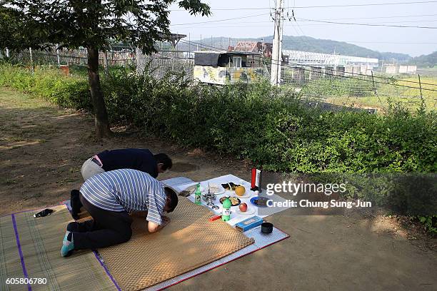 North Korean refugee Kim Young-Chil and his family members pay respects to their ancestors in North Korea during a ceremony to mark the Chuseok, the...
