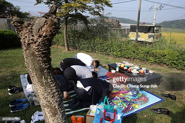 North Korean refugee Hyun Sang-Tae and his family members pay respects to their ancestors in North Korea during a ceremony to mark the Chuseok, the...