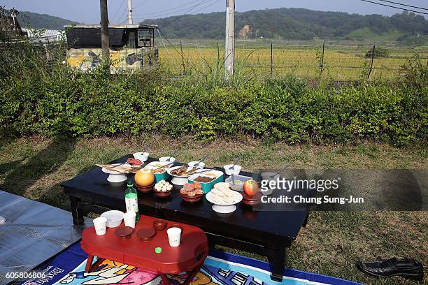 Memorial service table is prepared in front of a barbed wire fence during a ceremony to mark the Chuseok, the Korean Thanksgiving Day, at the...