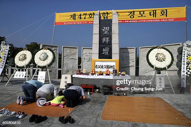 North Korean refugee Kim Chang-Yeop and his family members pay respects to their ancestors in North Korea during a ceremony to mark the Chuseok, the...